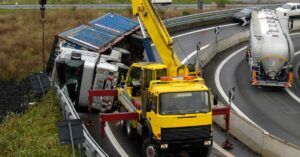 Overturned tanker truck being recovered by a crane on a highway, illustrating serious truck accident claims at Welcome Law Firm in Bridgeport