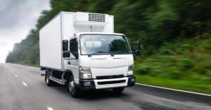 White box truck traveling on a highway, representing truck accident cases handled by Welcome Law Firm: Bridgeport Personal Injury & Immigration Lawyer