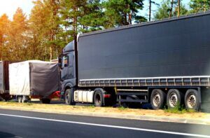 Large semi truck parked along a wooded roadside, depicting truck accident matters handled by Welcome Law Firm in Bridgeport